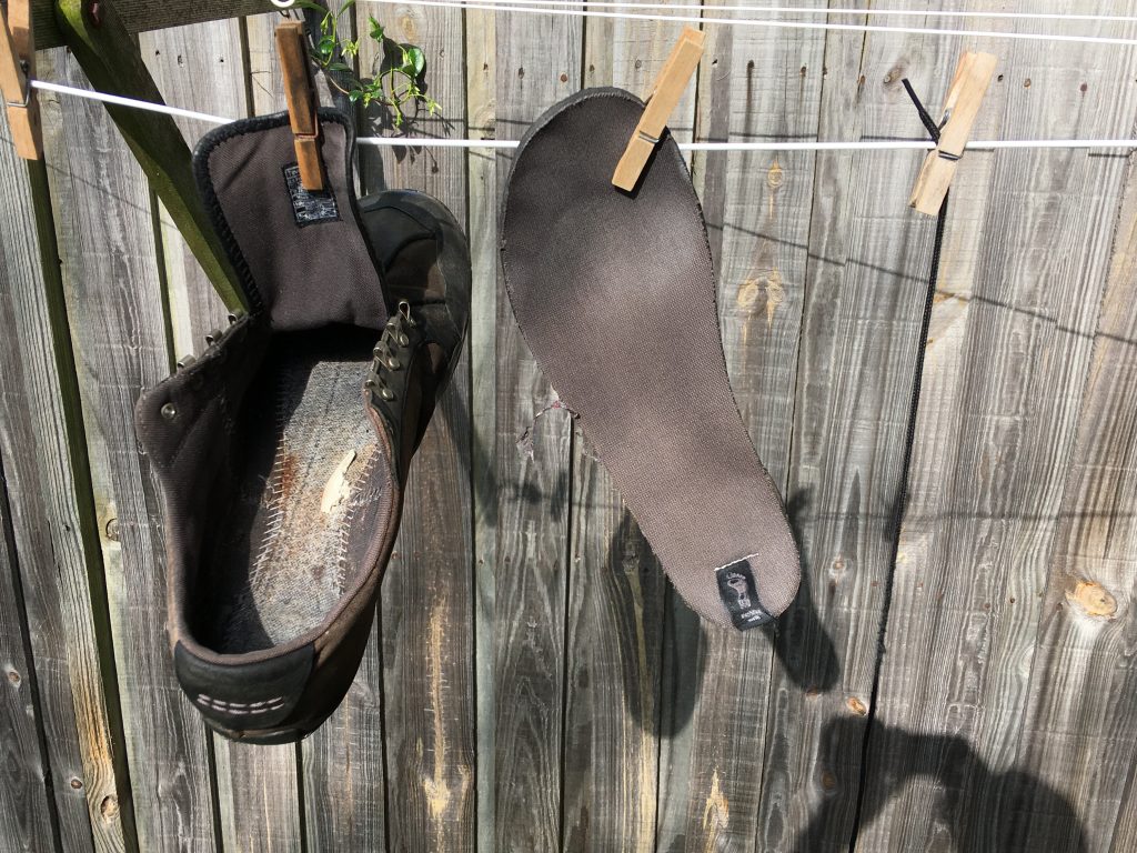 Drying wet shoe on clothesline
